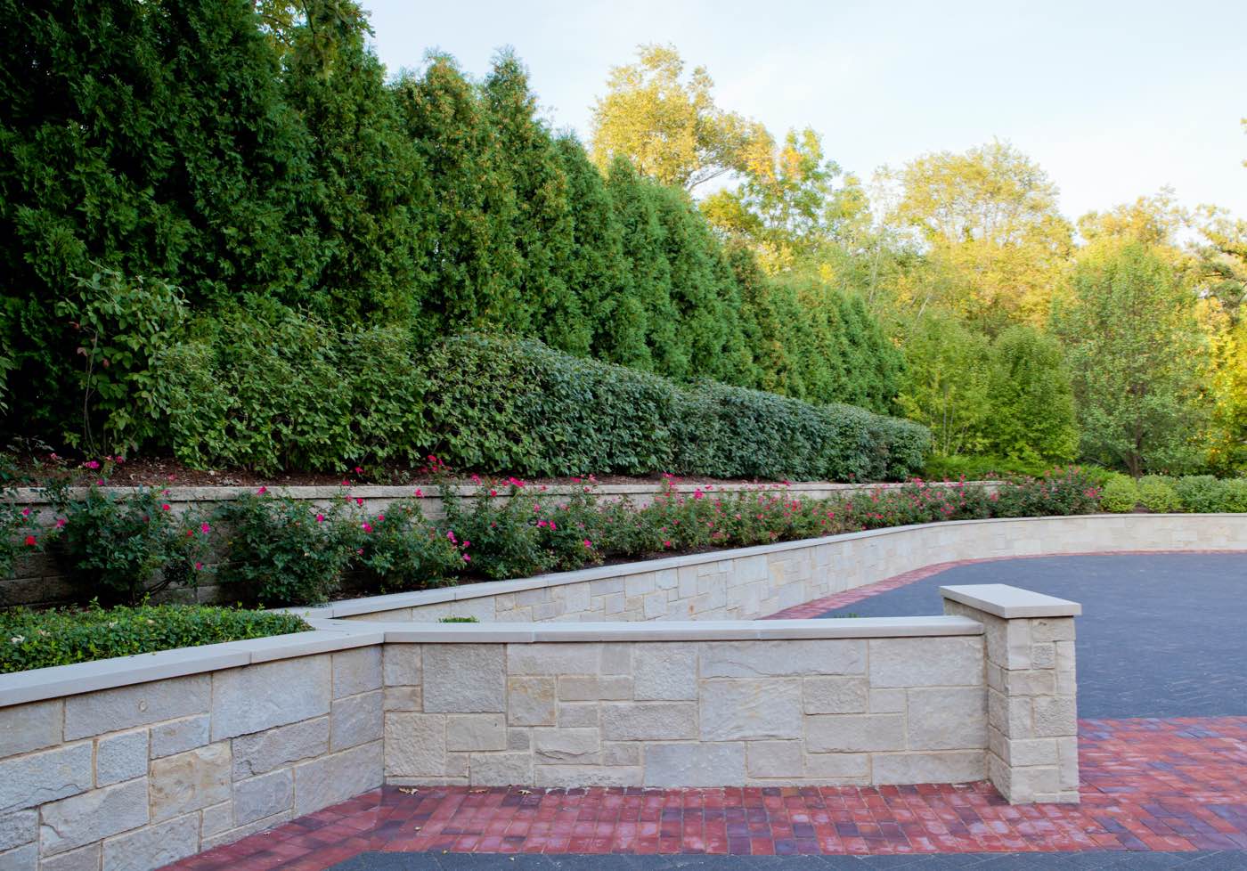 Stone retaining wall and tiered landscaping