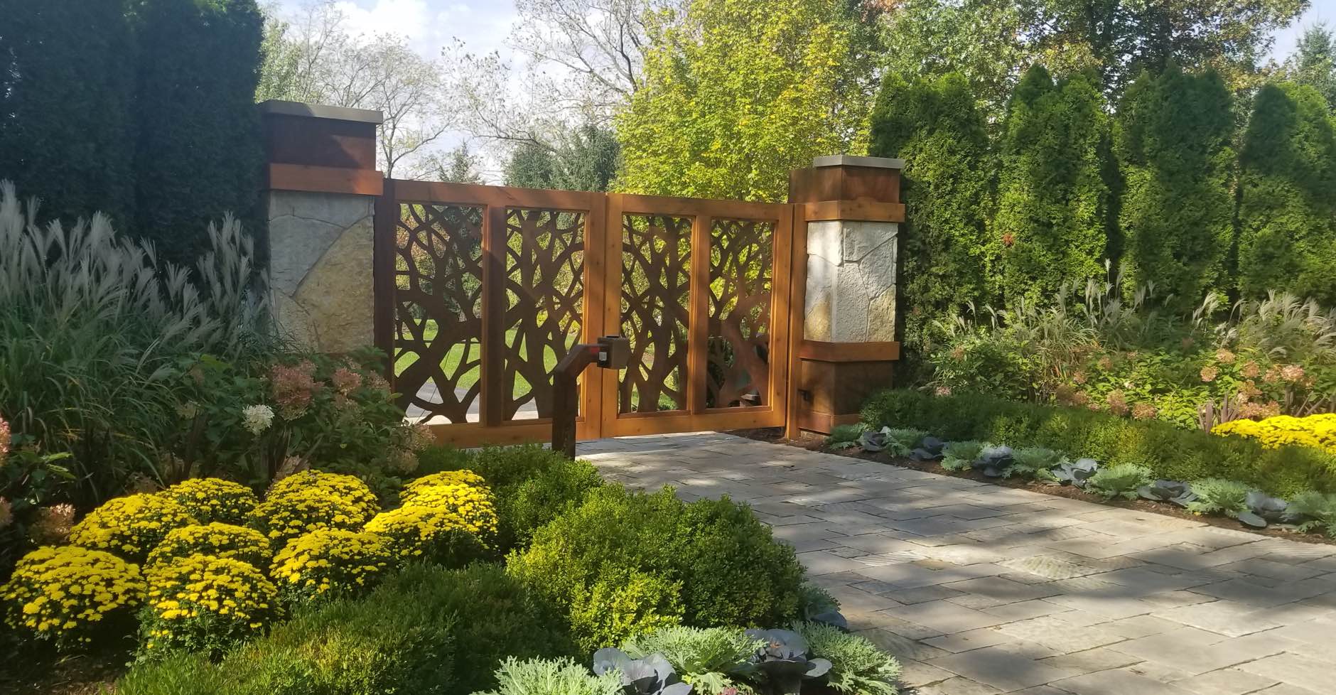 Decorative stone, wood and steel driveway gate
